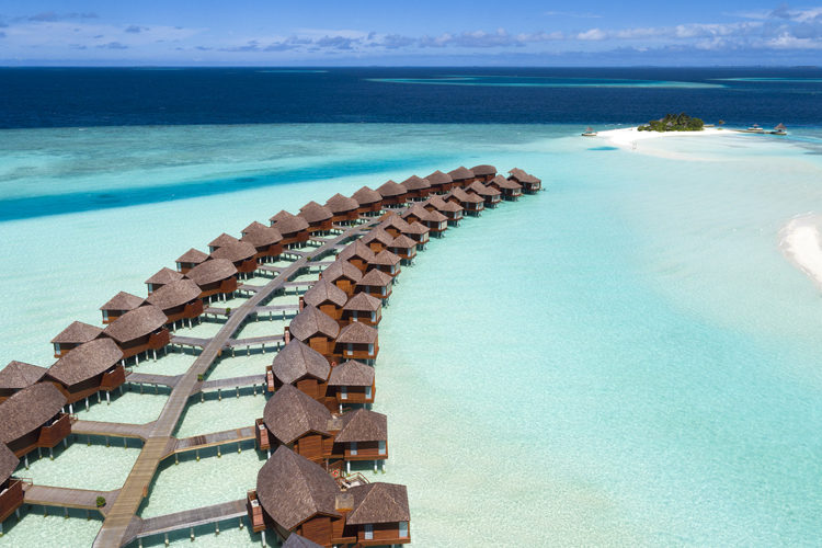 Anantara Dhigu view of overwater suites and blue lagoon