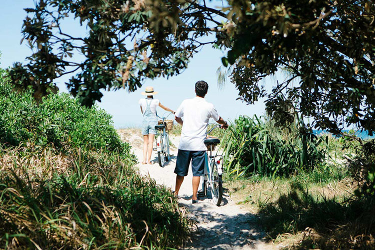 couple riding bikes at Halcyon House