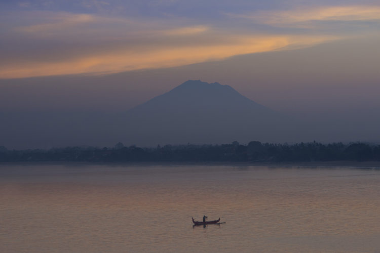 Sunset view across ocean to Mount Agung